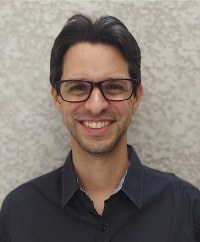 Victor Augusto Forti. White man with short, brown hair, short beard and brown eyes, wearing black-frammed sunglasses.